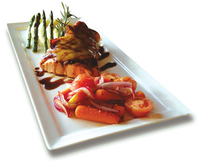 Chester V’s maple bacon-wrapped salmon drizzled in balsamic vinaigrette, topped with pineapple mango chutney. Photo by Julia Schnese