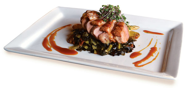 Rye’s Maple-Glazed Duck, which is pan-roasted, topped with braised greens and bacon, finished with a maple glaze and served with fingerling potatoes. Photo by Julia Schnese