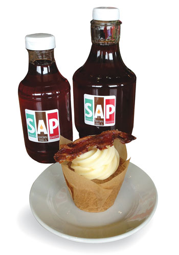 SAP’s signature cupcake topped with maple cream cheese icing and candied bacon. Photo by Julia Schnese